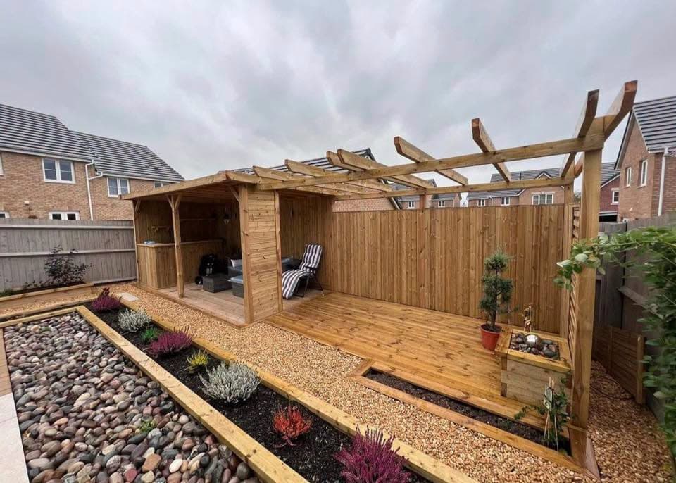 Garden room with pergola and planted borders in Cardiff