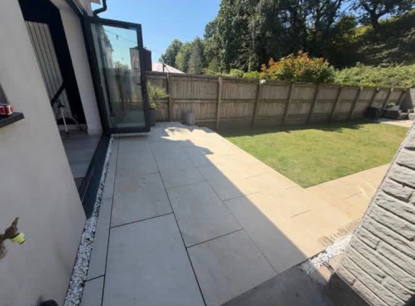 Premium artificial lawn installed alongside a bespoke porcelain patio in Cardiff