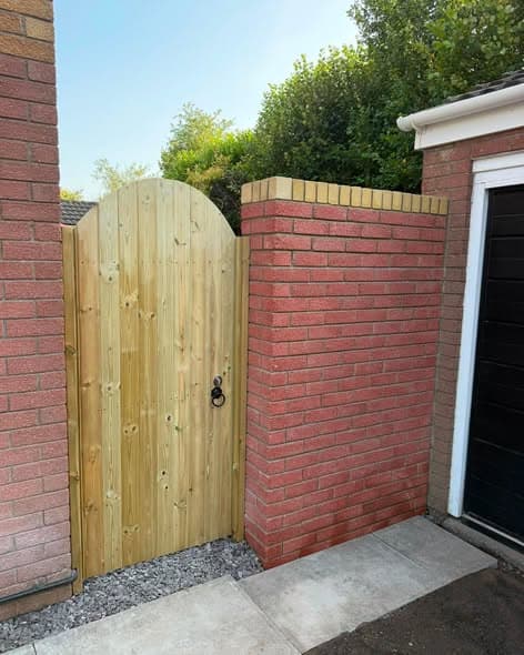 Bespoke timber garden gate fitted between brick walls