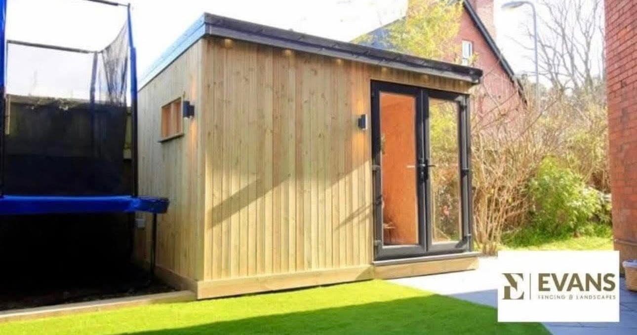 Bespoke cedar-clad garden room with black bi-fold doors, built by Evans Fencing & Landscapes